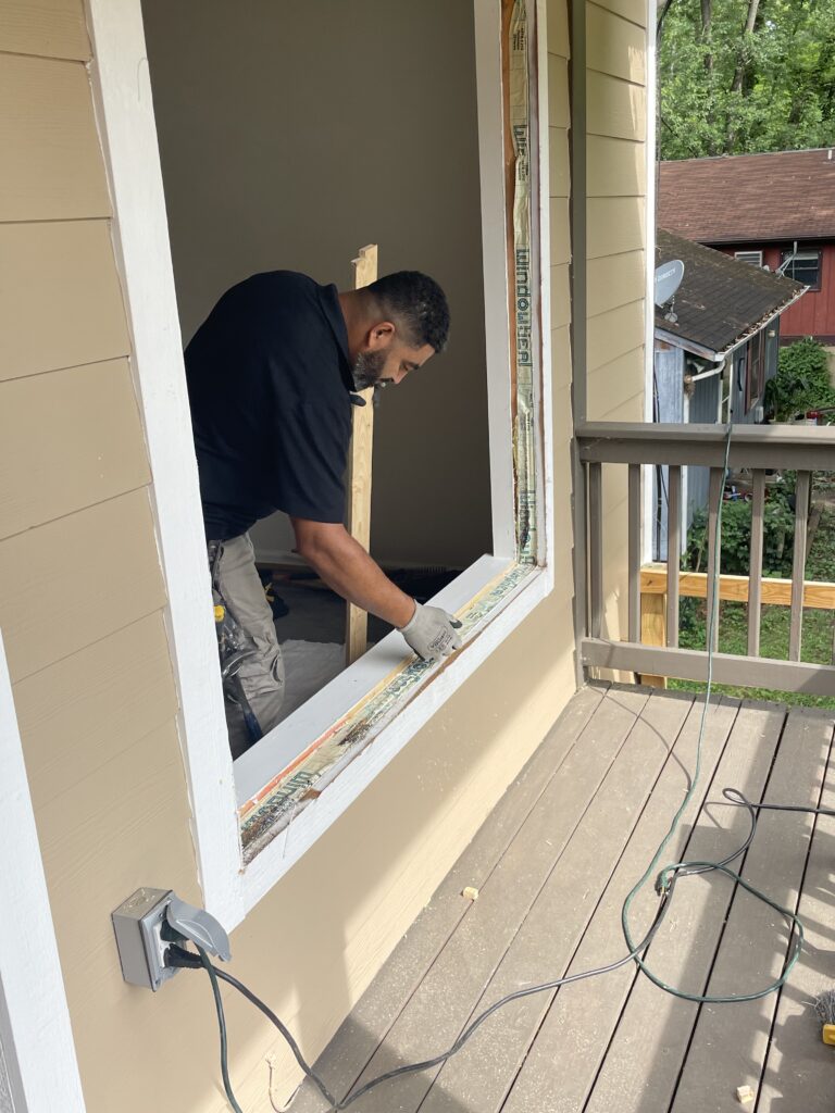 Renewal by Andersen installation crew installs replacement windows.