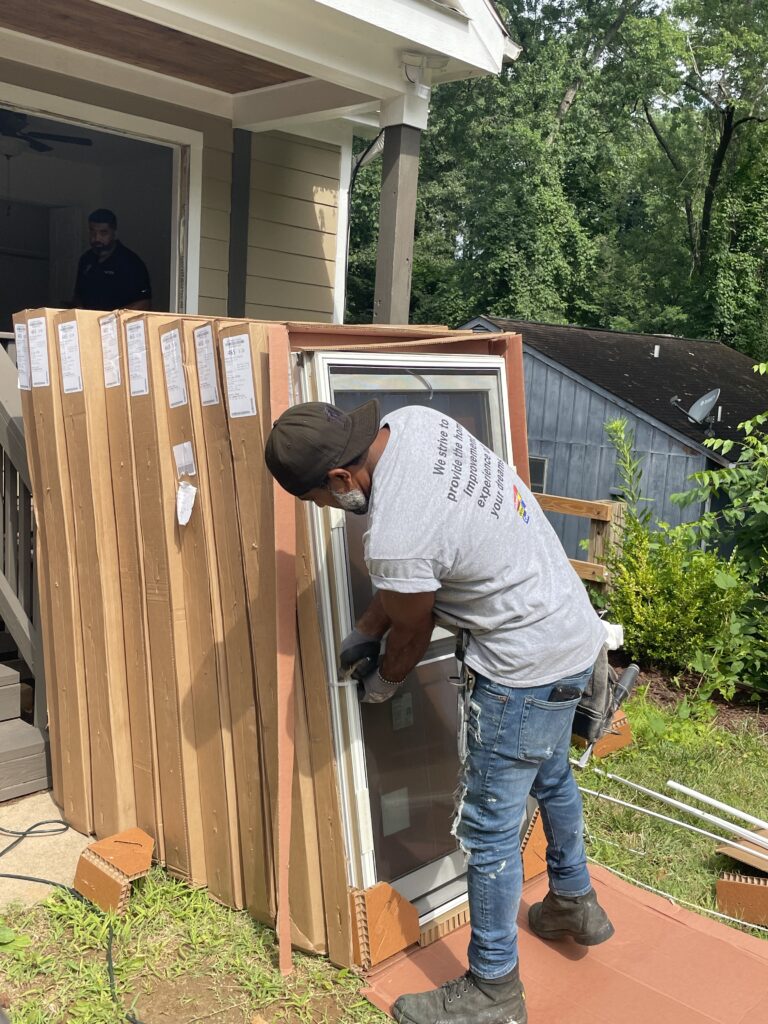Renewal by Andersen installation crew installs replacement windows.