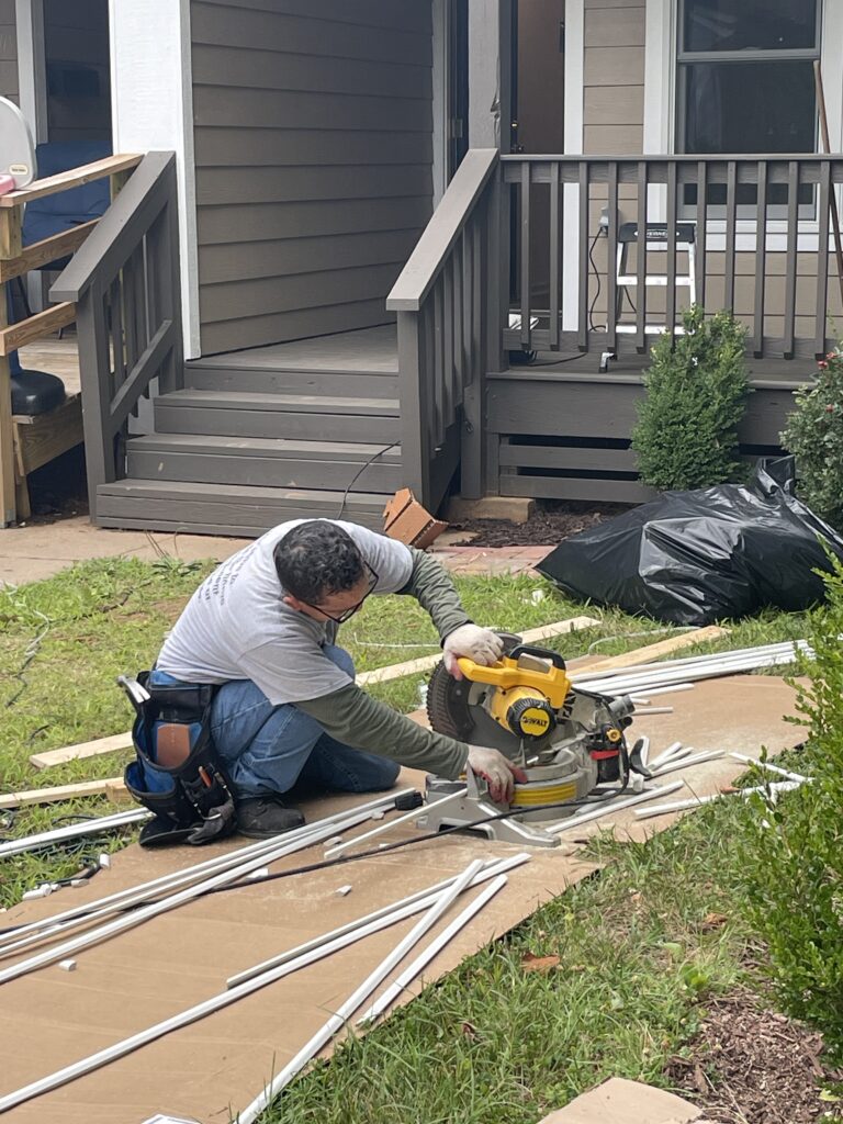 Renewal by Andersen installation crew installs replacement windows.