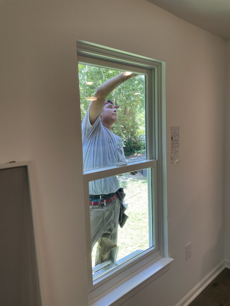 Renewal by Andersen installation crew installs replacement windows.