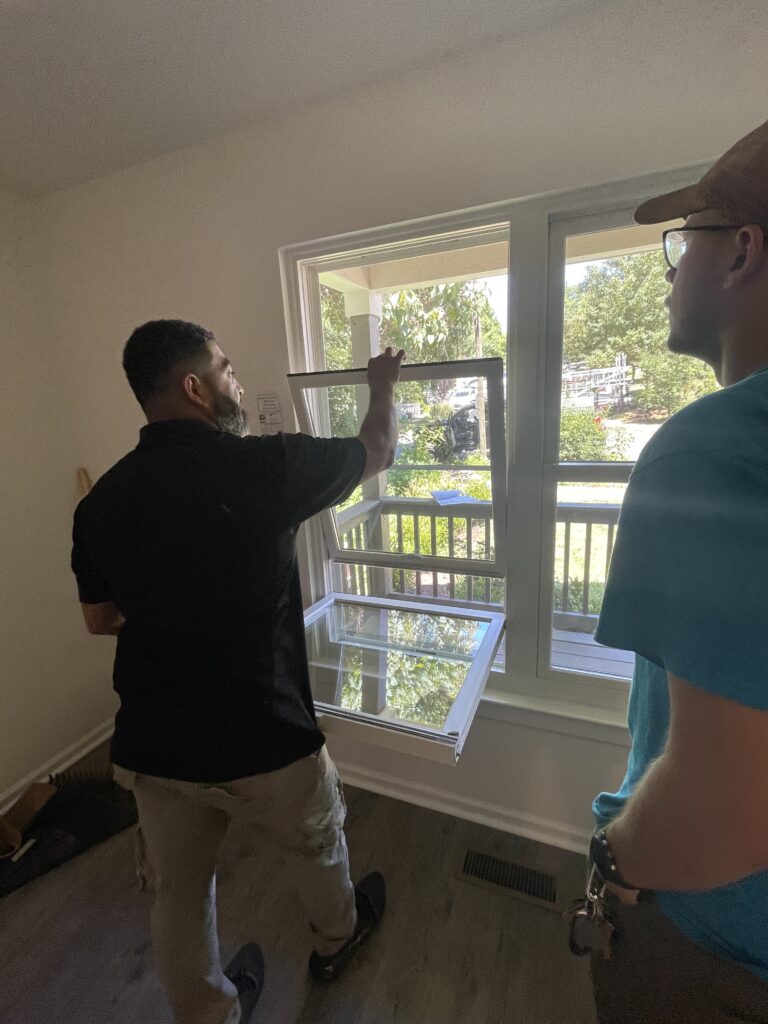 Renewal by Andersen installation crew installs replacement windows.