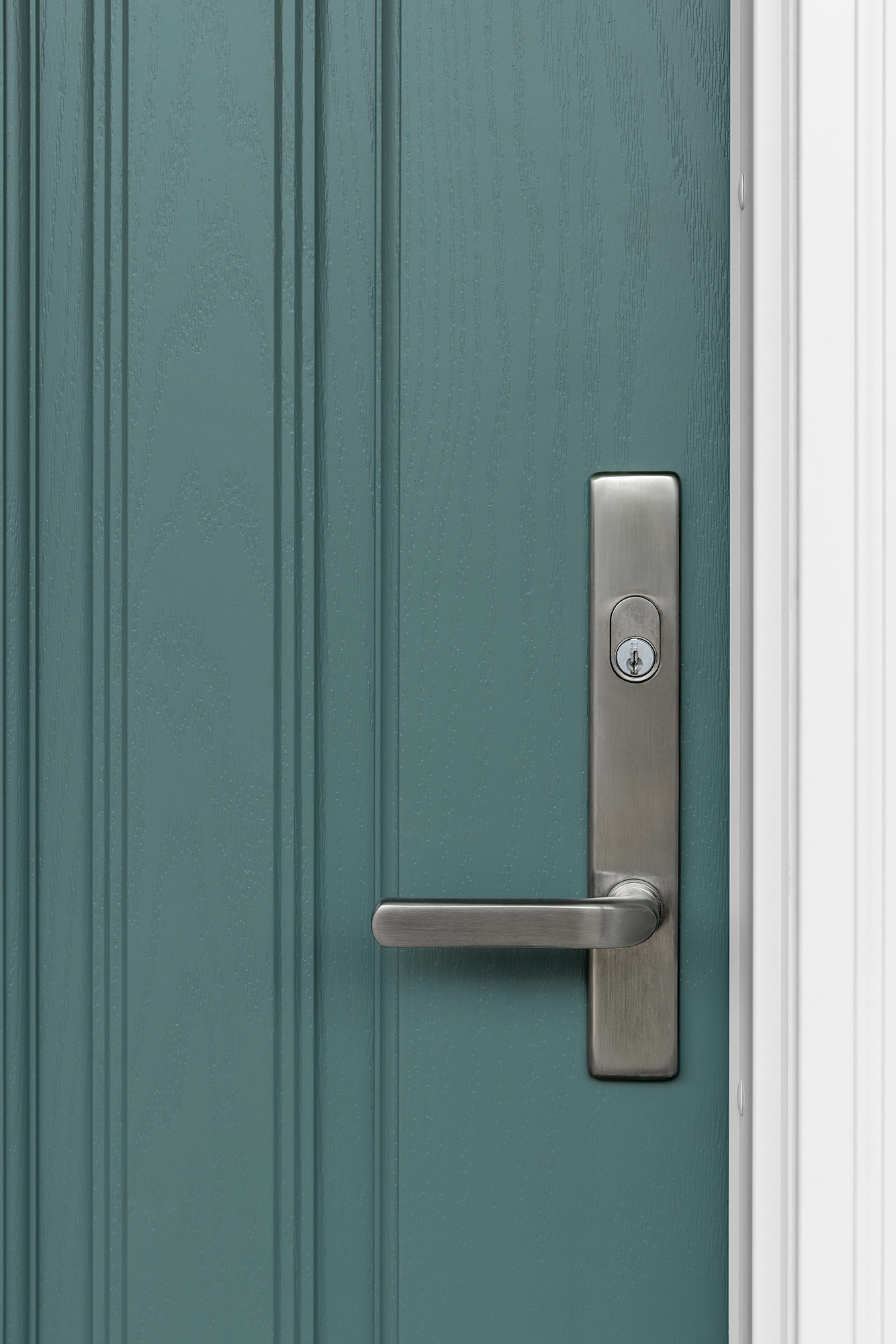 Silver door handle on turquoise door