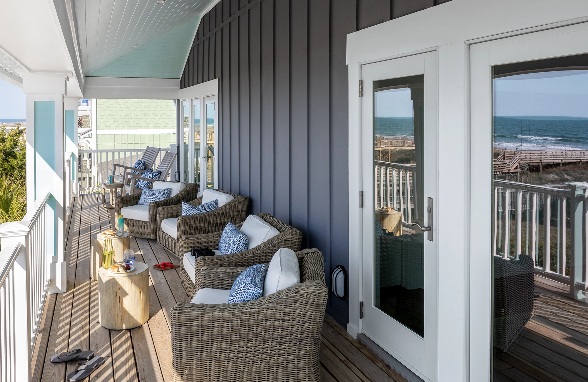 Glass patio doors leading to balcony with line of chairs