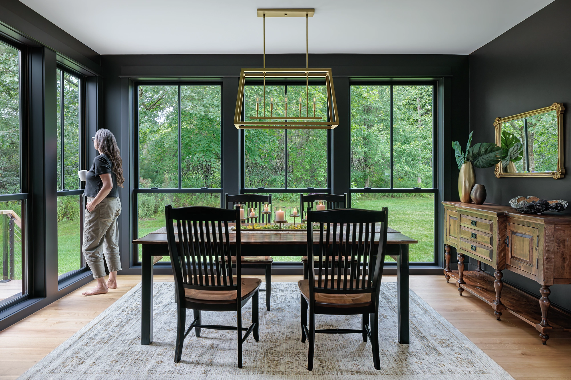 Woman looking out of a window in a dining room
