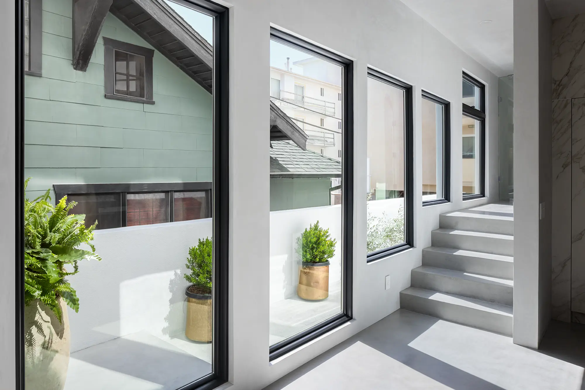 Black picture windows looking out to a patio