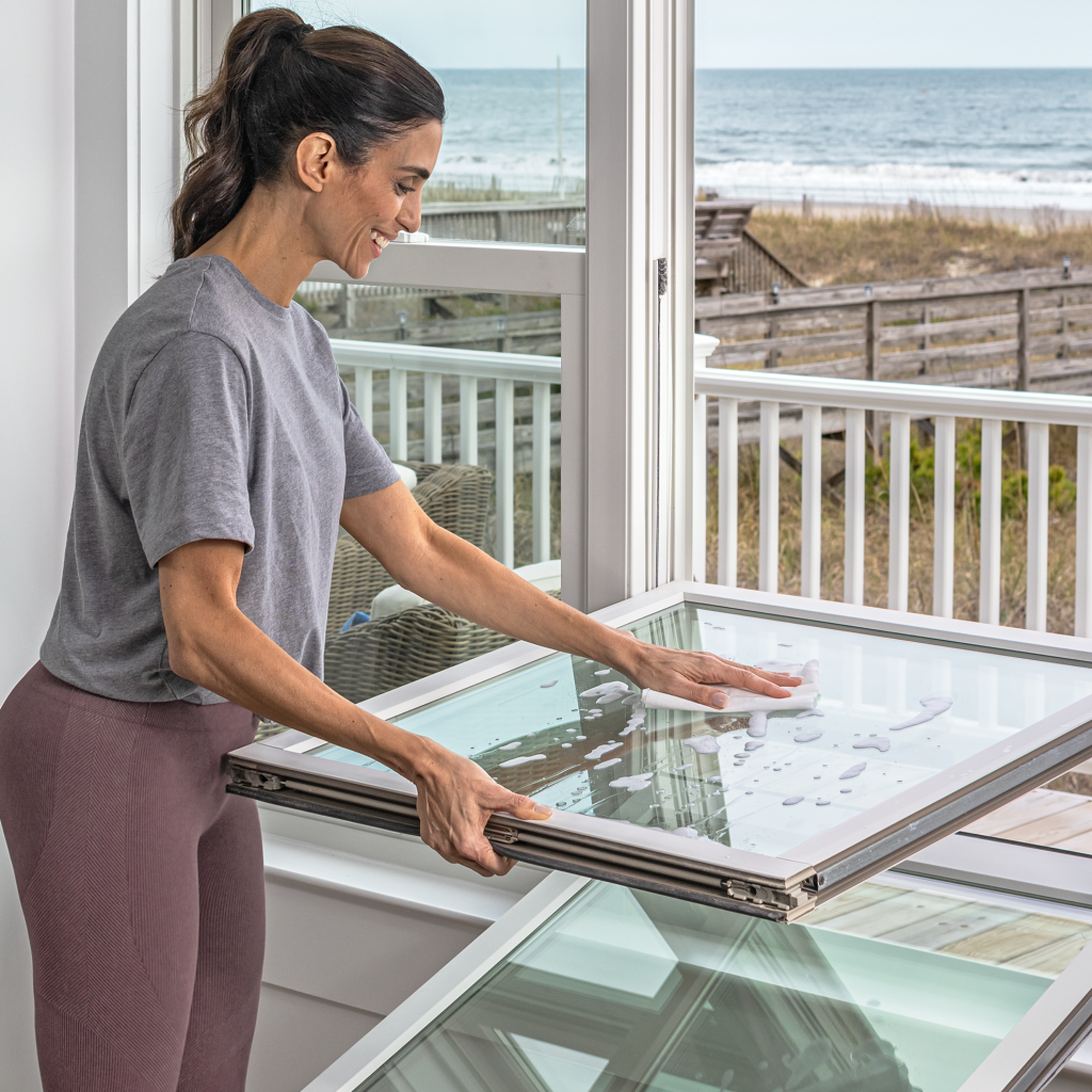 Woman cleaning window with soap