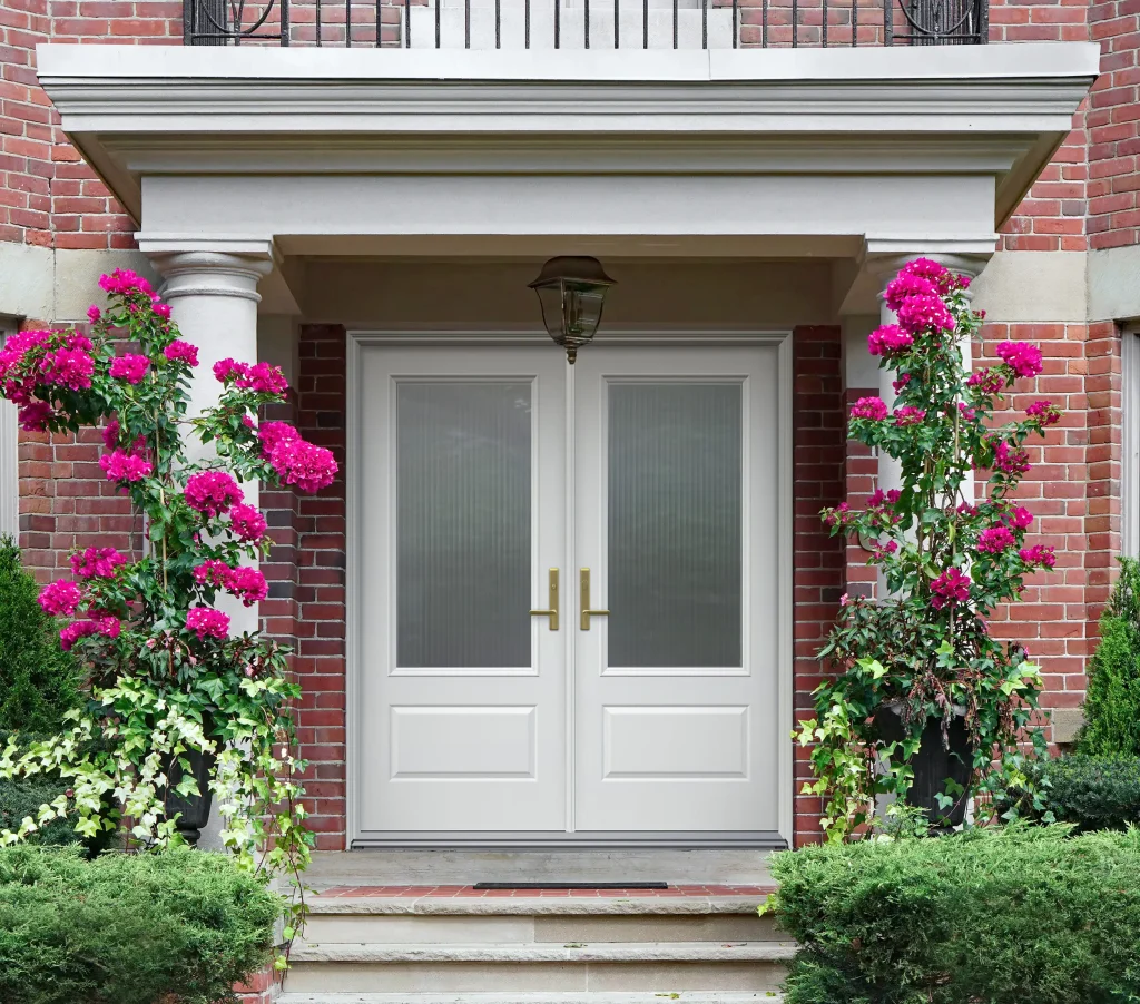 White doors surrounded by bright flowers