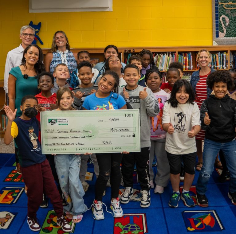 Renewal by Andersen employees and children smiling with a large check