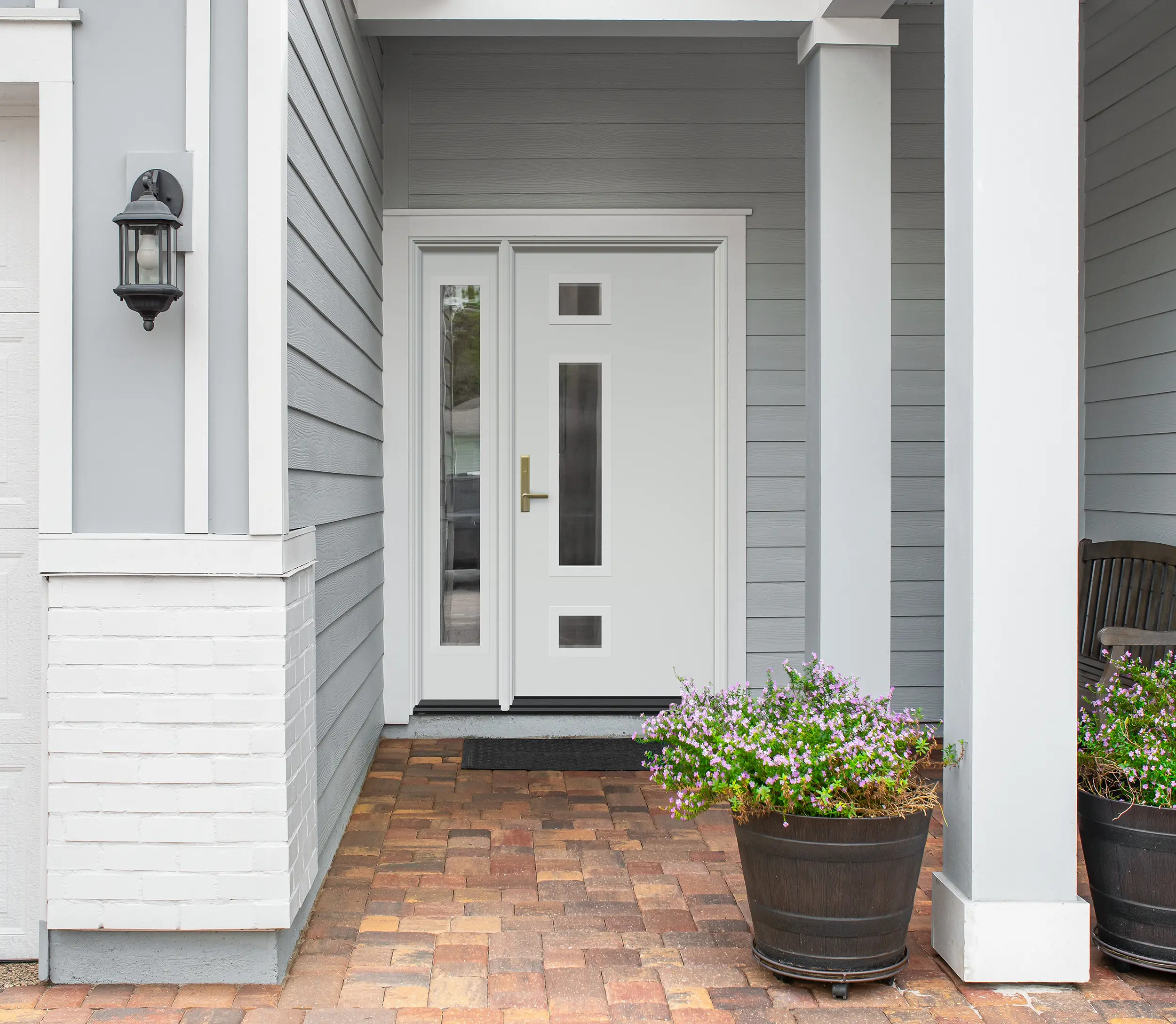 White door with inset windows and vertical window to the left