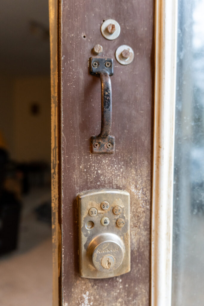 Close up on the original damaged door lock.