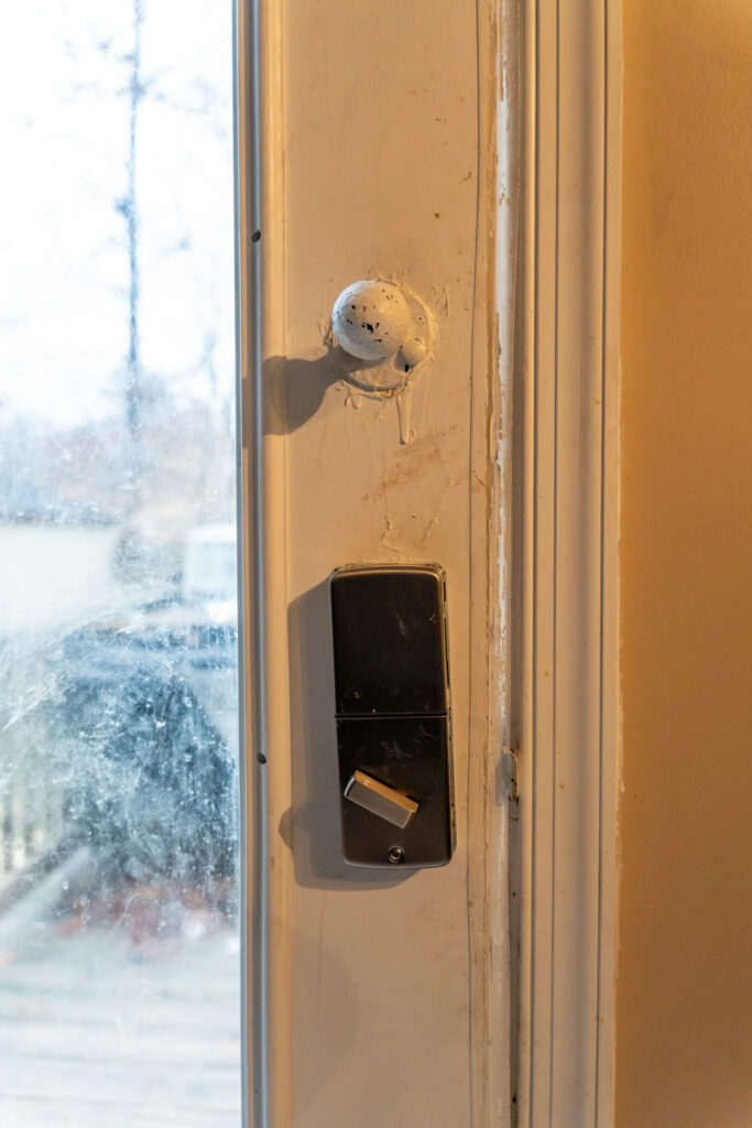 Close up of the original damaged door lock on the inside.
