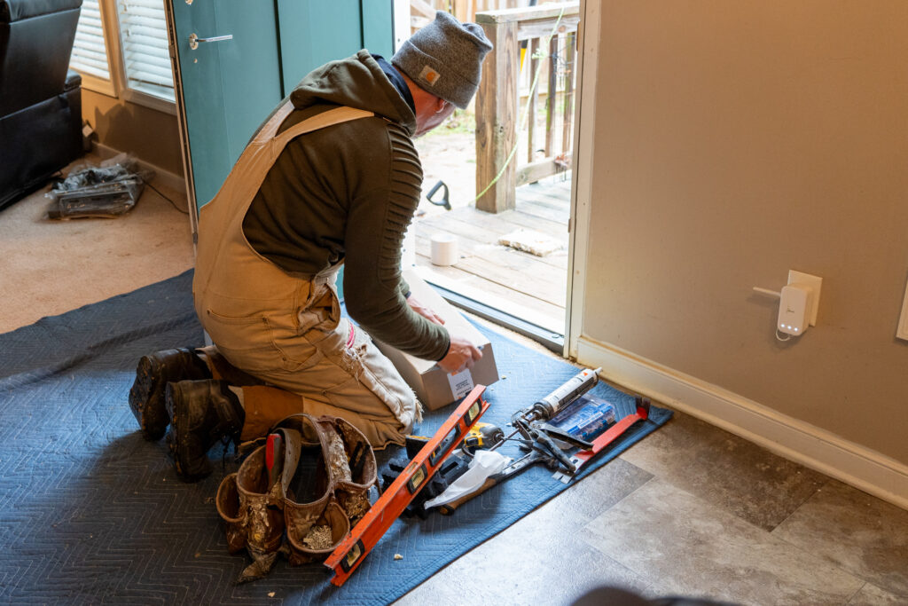 Renewal by Andersen master installer working on replacing the exterior door. 