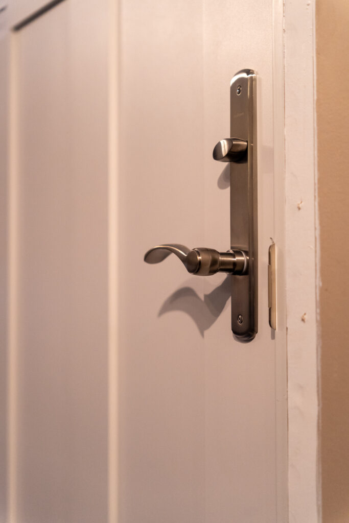 Brand new Renewal by Andersen Ensemble entry door, close up interior door handle and lock.