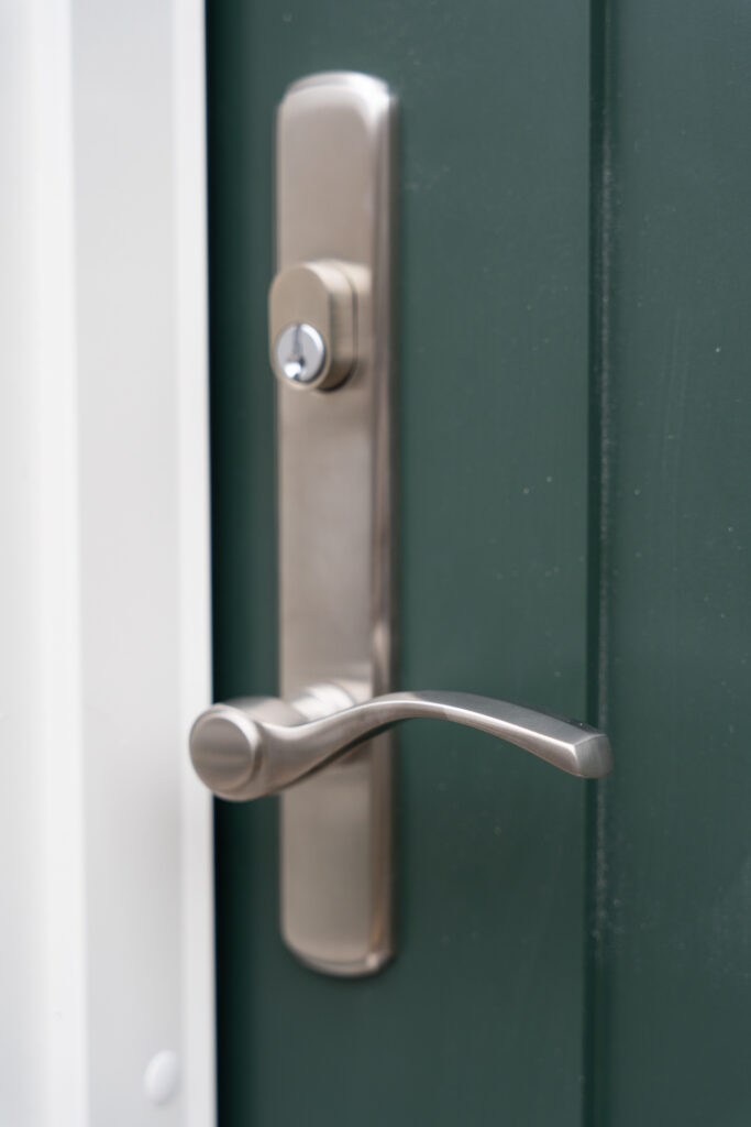 Brand new Renewal by Andersen Ensemble entry door, close up exterior door handle and lock.