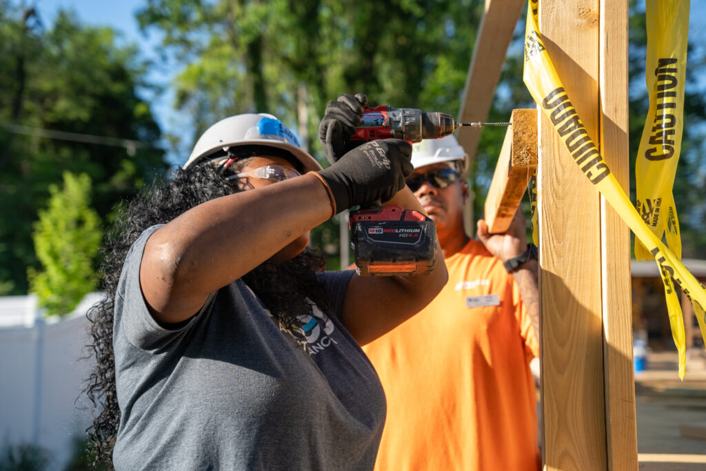 Renewal by Andersen of Roanoke team member drilling at Habitat for Humanity