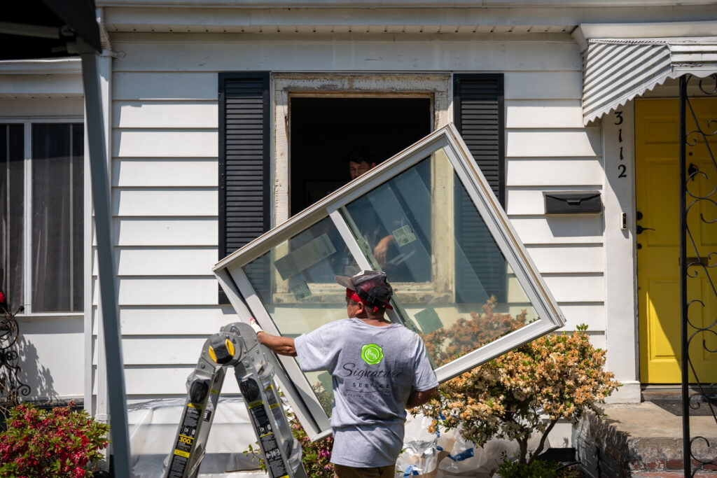 Renewal by Andersen installer moving a replacement window