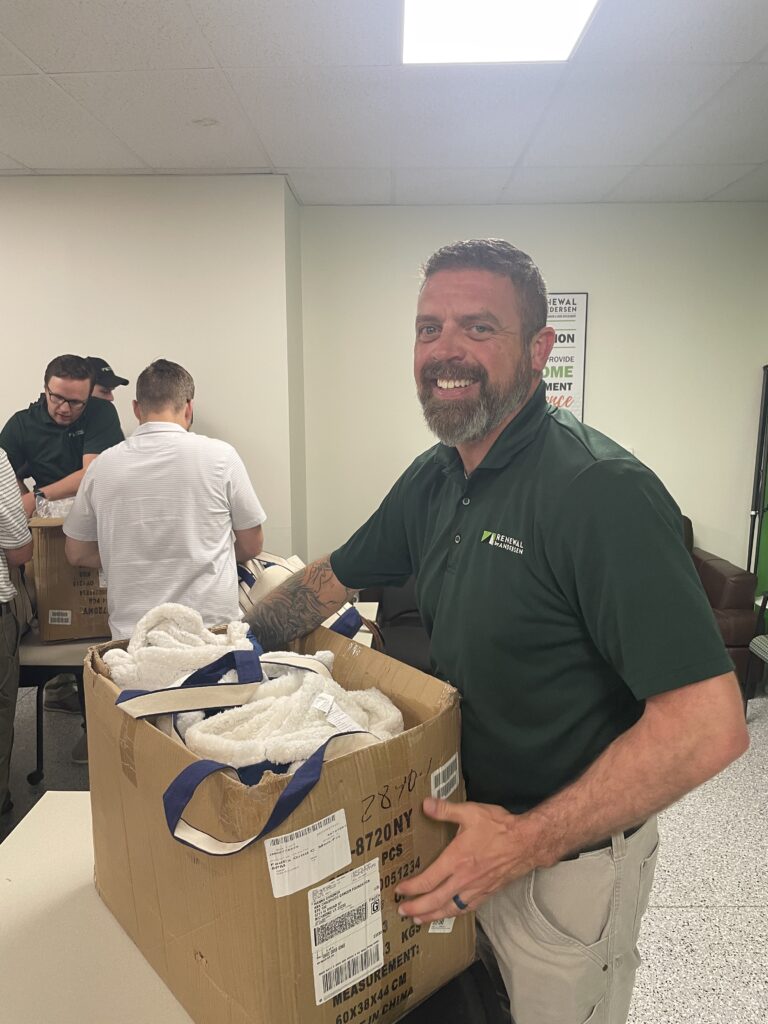 Renewal by Andersen of Central Virginia sales team members packing bags for ASK Childhood Cancer Foundation