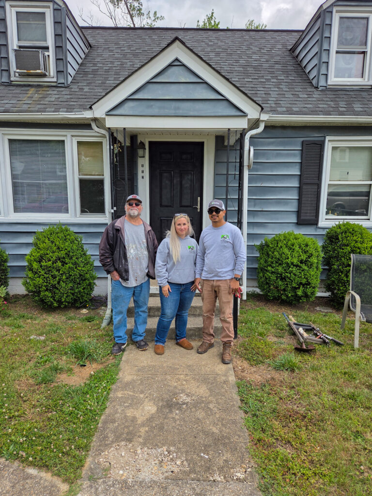 Renewal by Andersen team standing in front of the new replacement door.