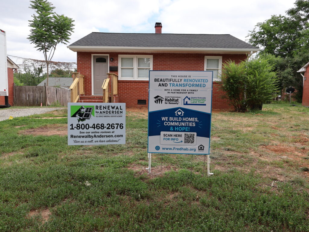Fredericksburg Habitat for Humanity house with Renewal by Andersen yard sign.