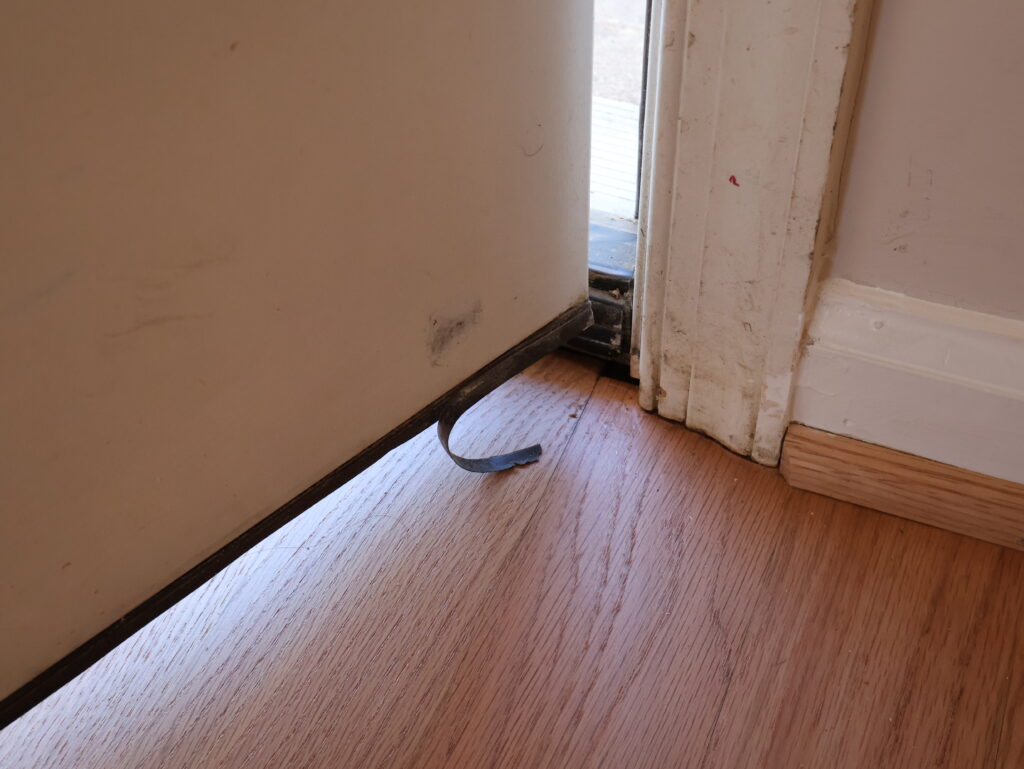 Previous door, close up on broken seal.