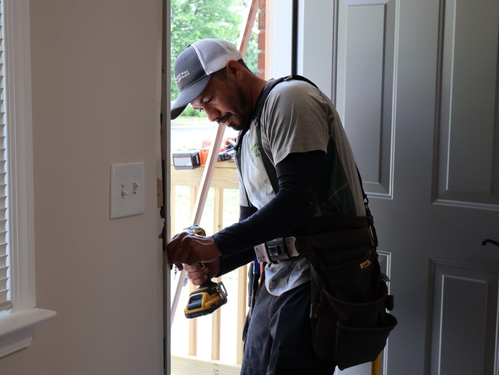 Renewal by Andersen installation team working on replacement door.