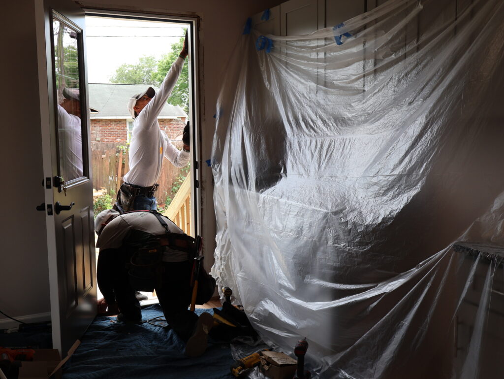 Renewal by Andersen installation team working on replacement door.
