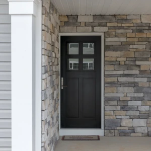 Black entry door surrounded by brick