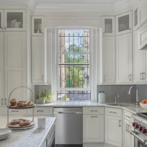 White double hung windows above a dishwasher in a kitchen