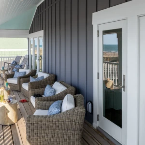 Glass patio doors leading to balcony with line of chairs
