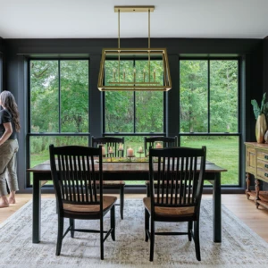 Woman looking out of a window in a dining room